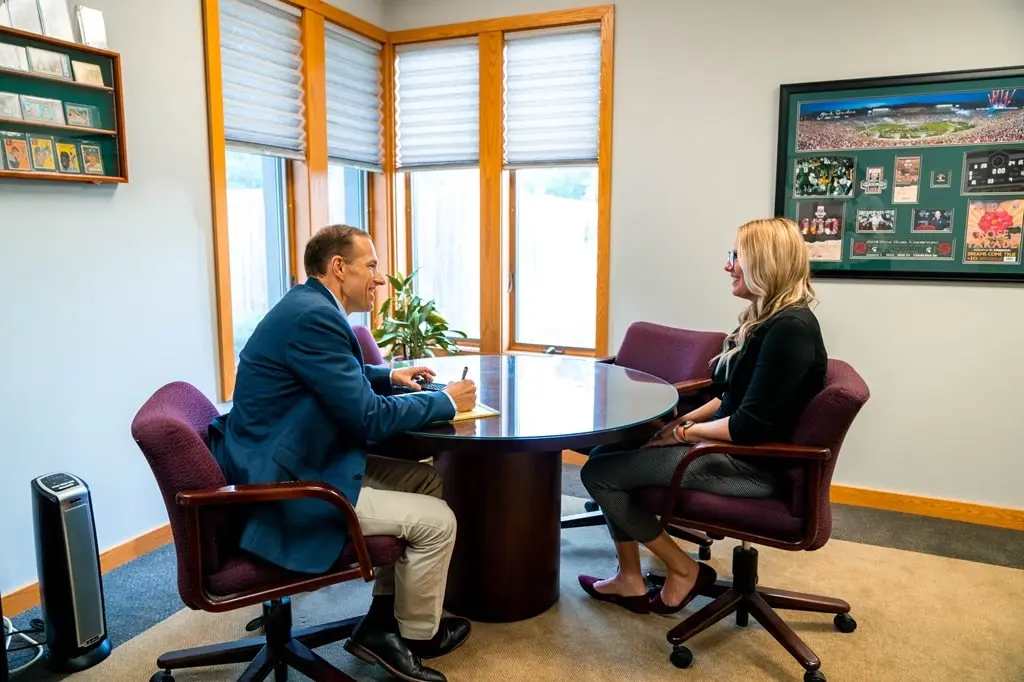Financial advisor at Wiser Financial Group discusses finances with a client.
