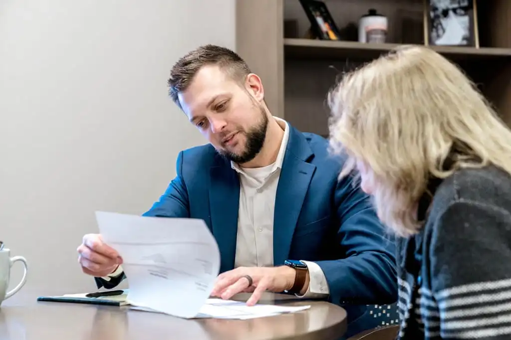A financial advisor goes over documentation with a female client.